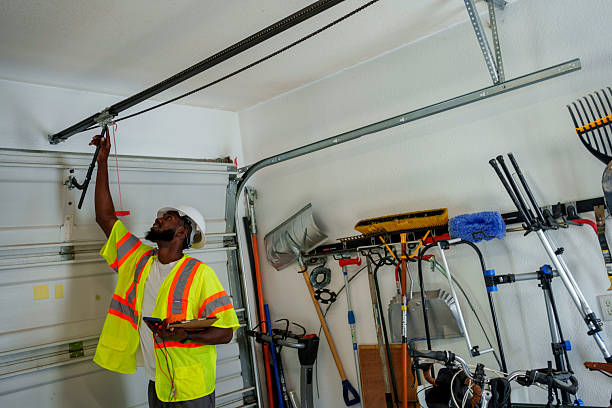 Professional Garage Door Panel Replacement technician working in Village Green-Green Ridge, PA